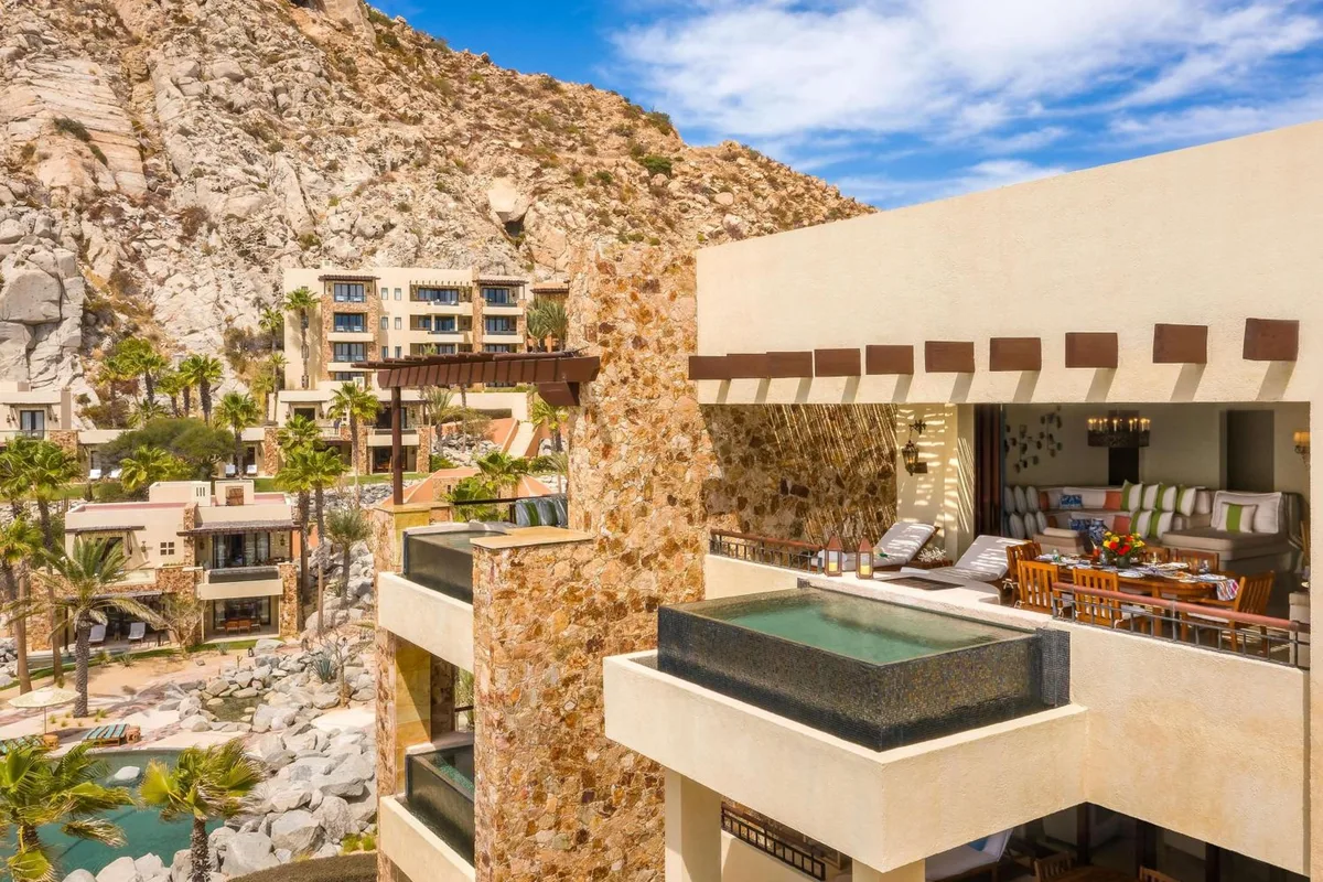 Private plunge pool on a suite terrace at Waldorf Astoria Los Cabos Pedregal, with the resort built into the cliffs behind it