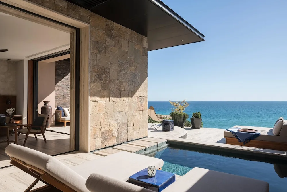 Beachfront suite terrace at Zadún with a private plunge pool, lounge chairs and stone walls facing the ocean
